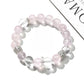 Lovra bracelet featuring alternating pink and white crystal beads displayed flat