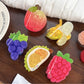 Close-up of orange fruit shaped hair claw clip with textured surface