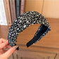 Wide vintage print headband packaged in branded box with product tag