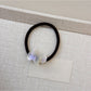 Gifty hair tie featuring a colorful cartoon puppy charm and bead accents