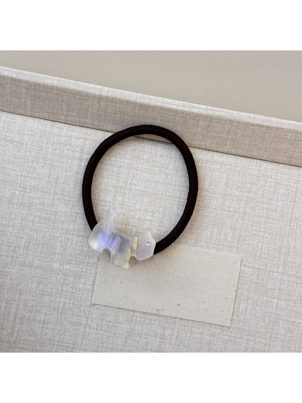 Gifty hair tie featuring a colorful cartoon puppy charm and bead accents