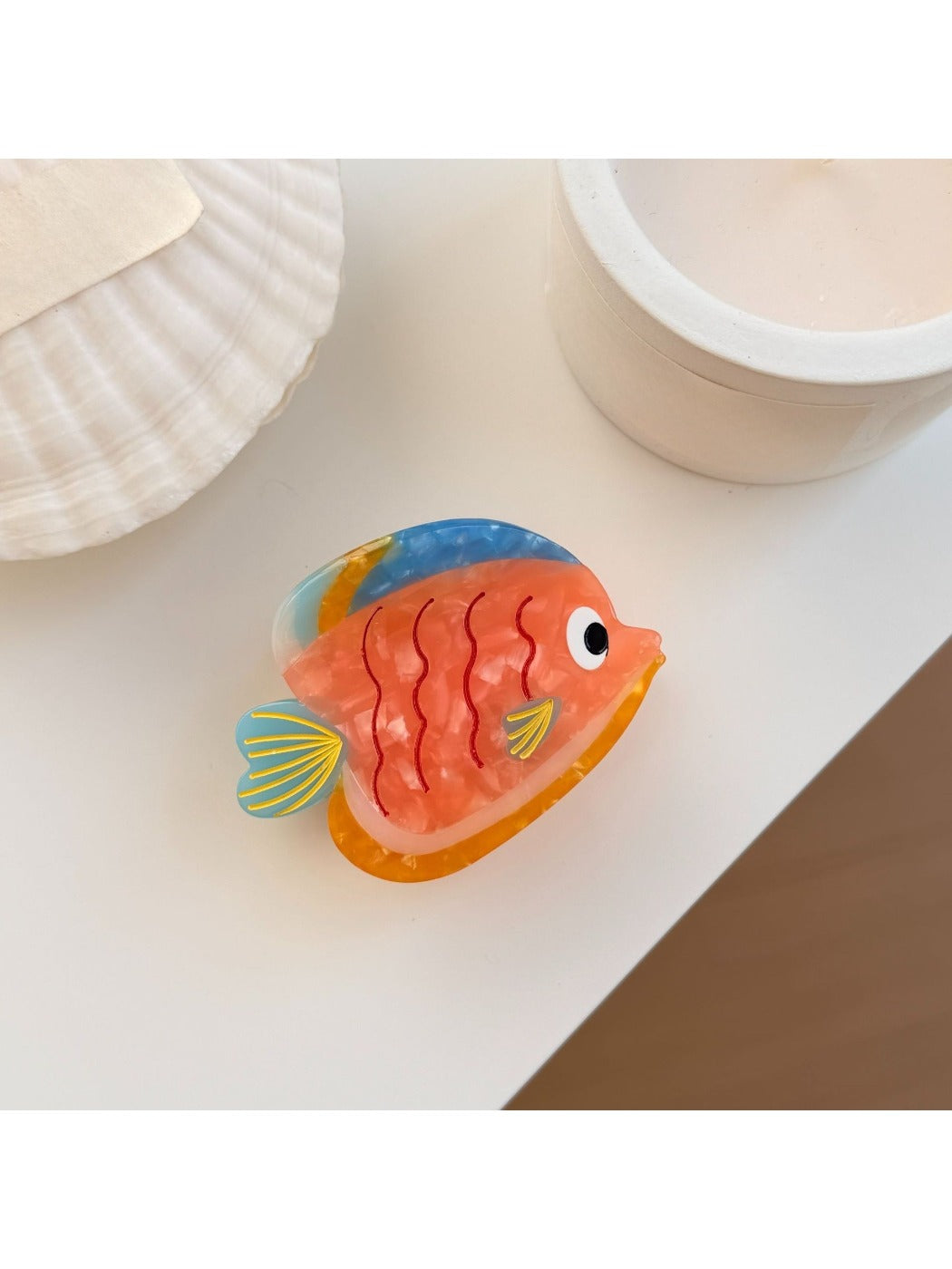 Beau fish claw clip showing the spring clasp and colorful fish design