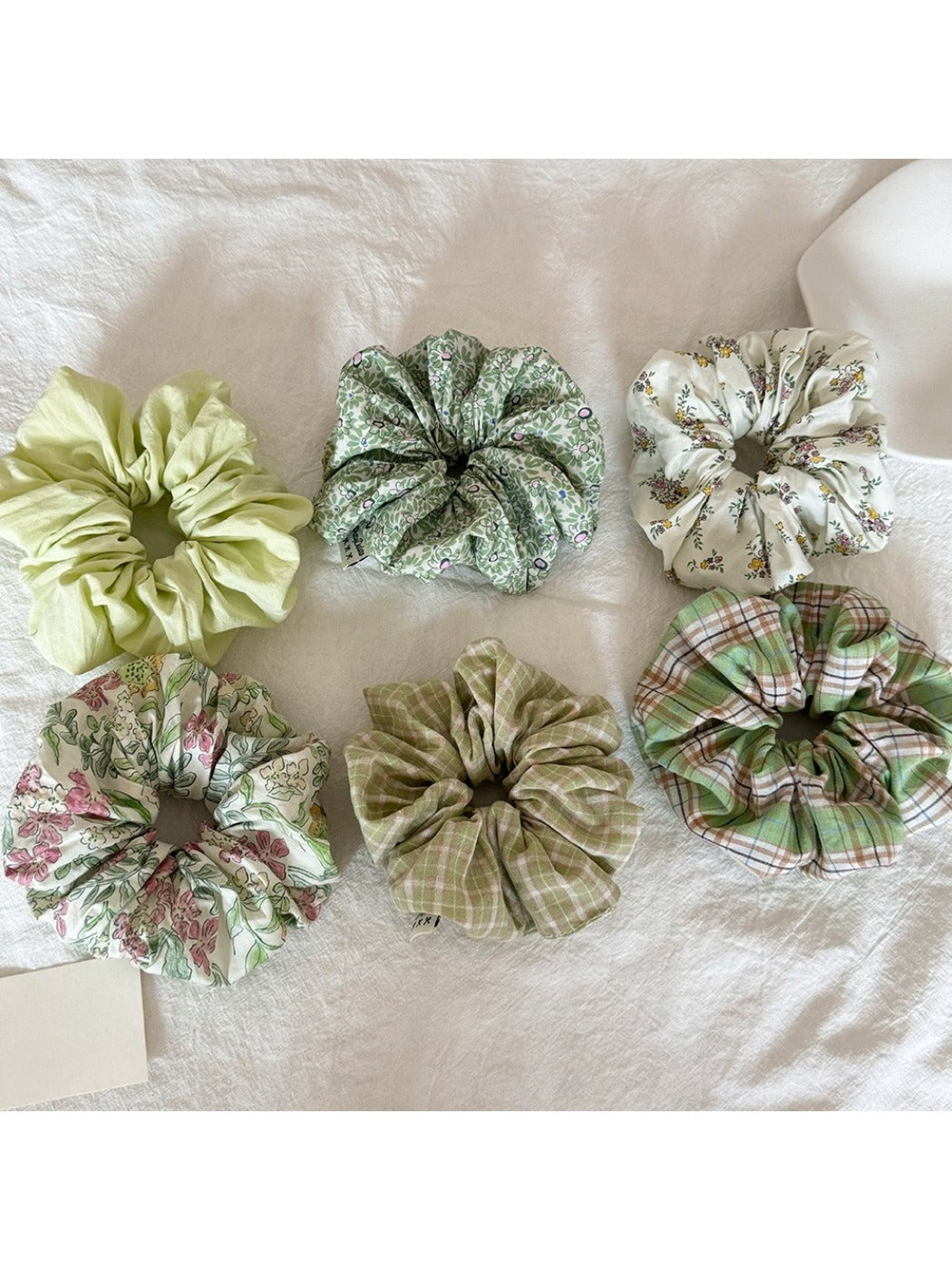 Close-up of Gifty Sweet Green Style Scrunchie made from soft green fabric
