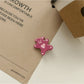 Rose hair tie wrapped around a bun hairstyle on medium brown hair