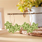 Earedge Sweet Flower Shaped Drop Earrings resting on a light fabric surface