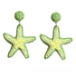 Starfish raffia earrings displayed with natural lighting highlighting texture