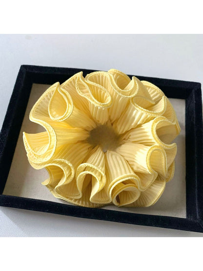 Gifty scrunchie placed next to matching minimalist outfit accessories