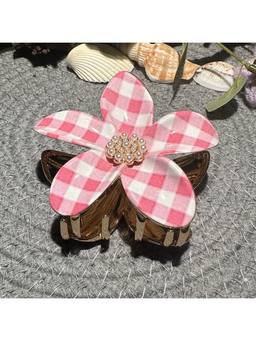 Beau checkered flower hair clip worn in brown hair, side view