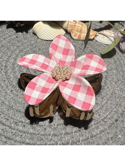 Beau checkered flower hair clip worn in brown hair, side view