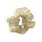 Gifty sheer tulle scrunchie worn on a wrist, highlighting its lightweight and floral details