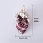 Plaid fabric strawberry umbrella keychain displayed on a wooden surface