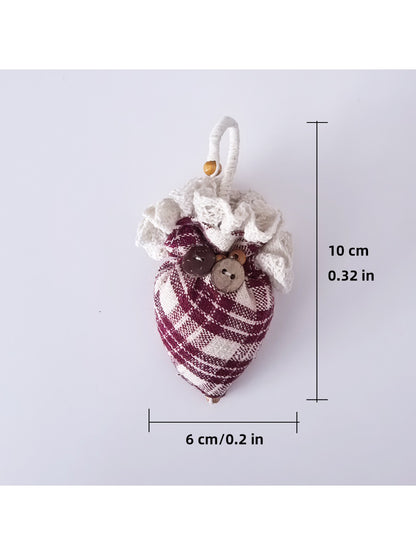 Plaid fabric strawberry umbrella keychain displayed on a wooden surface
