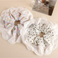Close-up of Gifty patchwork scrunchie showing detailed floral and checkered fabric design