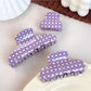 Beau purple plaid hair claw clip held in hand displaying size