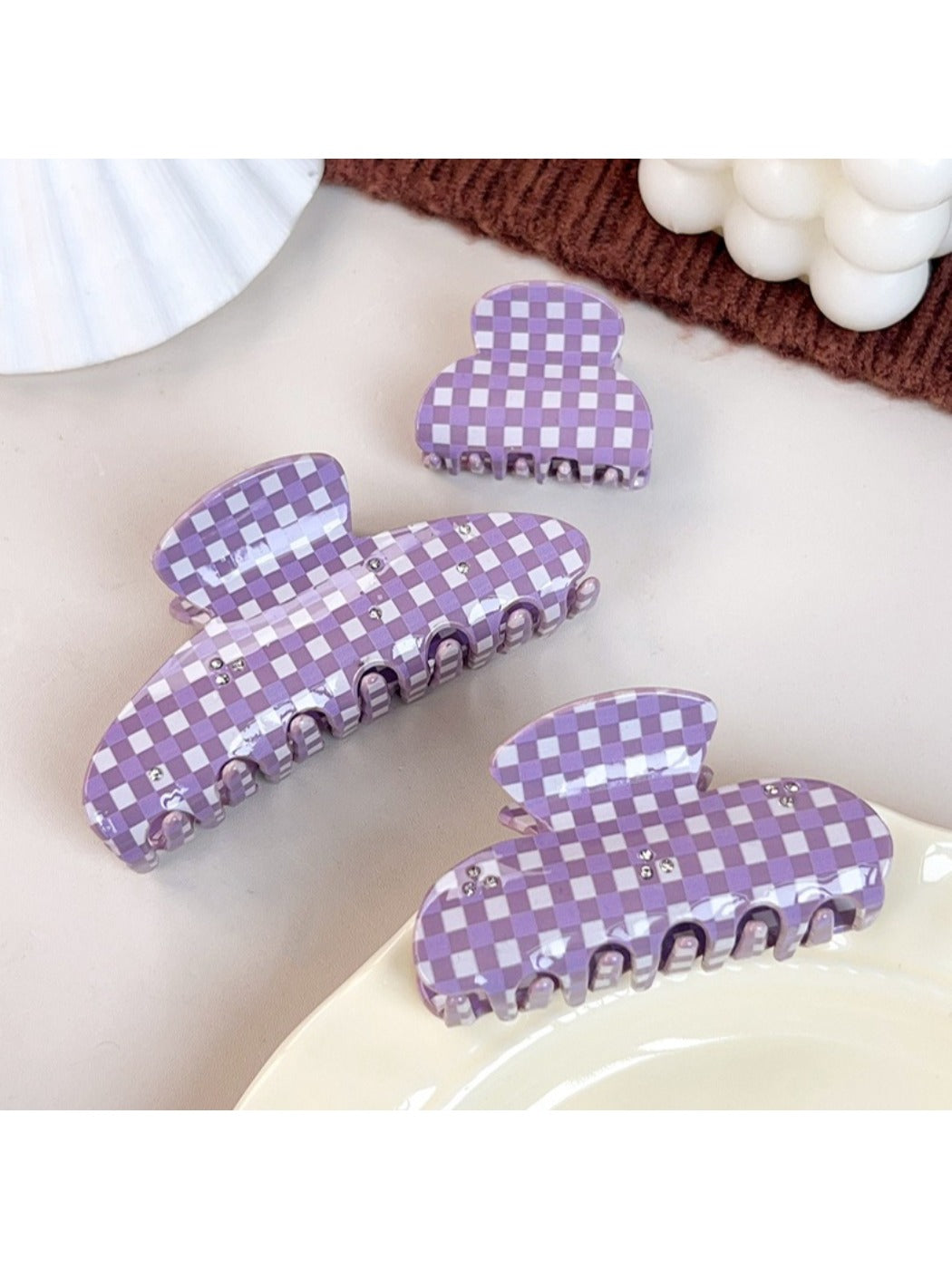 Beau purple plaid hair claw clip held in hand displaying size