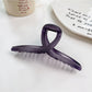 Beau square crisscross hair claw clip displayed on a wooden surface