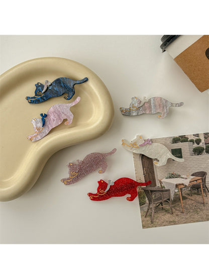 Beau cat hair clip attached to brown hair in a side view