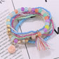 Lovra flower pendant bracelet coiled to show elastic band and bead arrangement