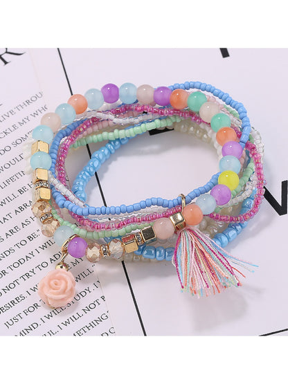 Lovra flower pendant bracelet coiled to show elastic band and bead arrangement