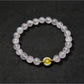 Lovra minimalist bracelet next to a small plant, emphasizing natural and simple style