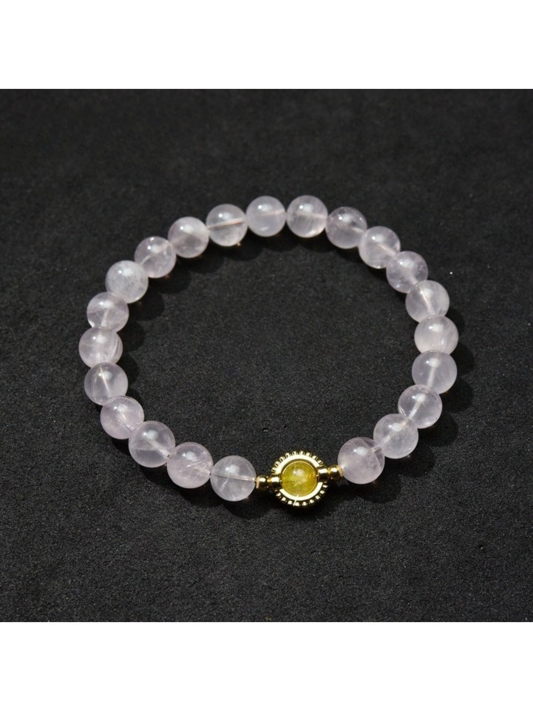 Lovra minimalist bracelet next to a small plant, emphasizing natural and simple style