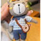 Bear charm keychain attached to a handbag zipper pull