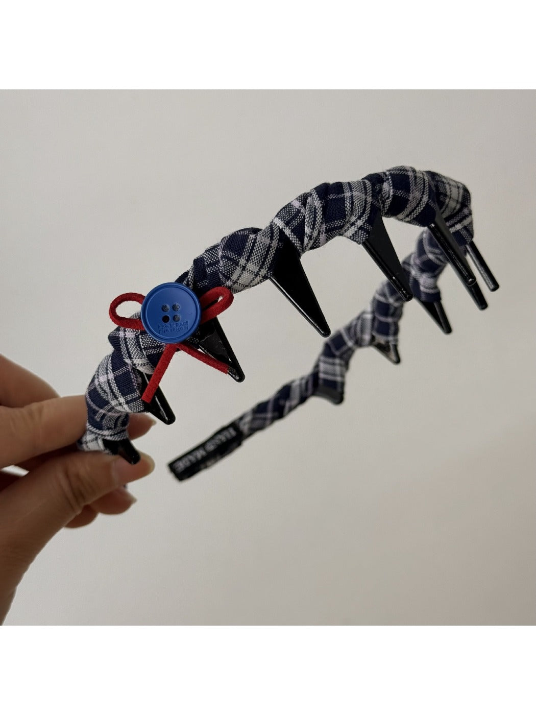 Blue headband folded neatly to highlight fabric and stitching