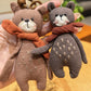 Side view of the bear keychain showing its detailed scarf and facial features