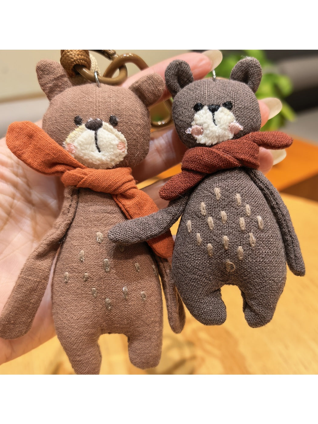 Side view of the bear keychain showing its detailed scarf and facial features