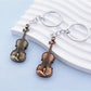 Vintage alloy guitar-shaped keychain with detailed strings and tuning pegs