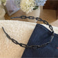 Side view of Gifty acetate chain style headband highlighting interlinked chain design