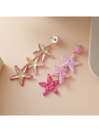 Earedge star pendant earrings displayed on a jewelry stand