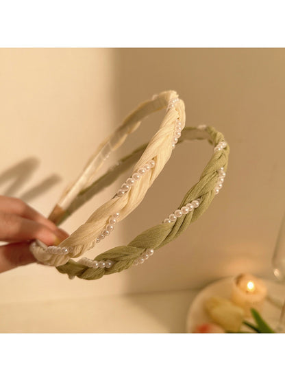 Side view of delicate beaded headband featuring tiny white beads on thin gold band