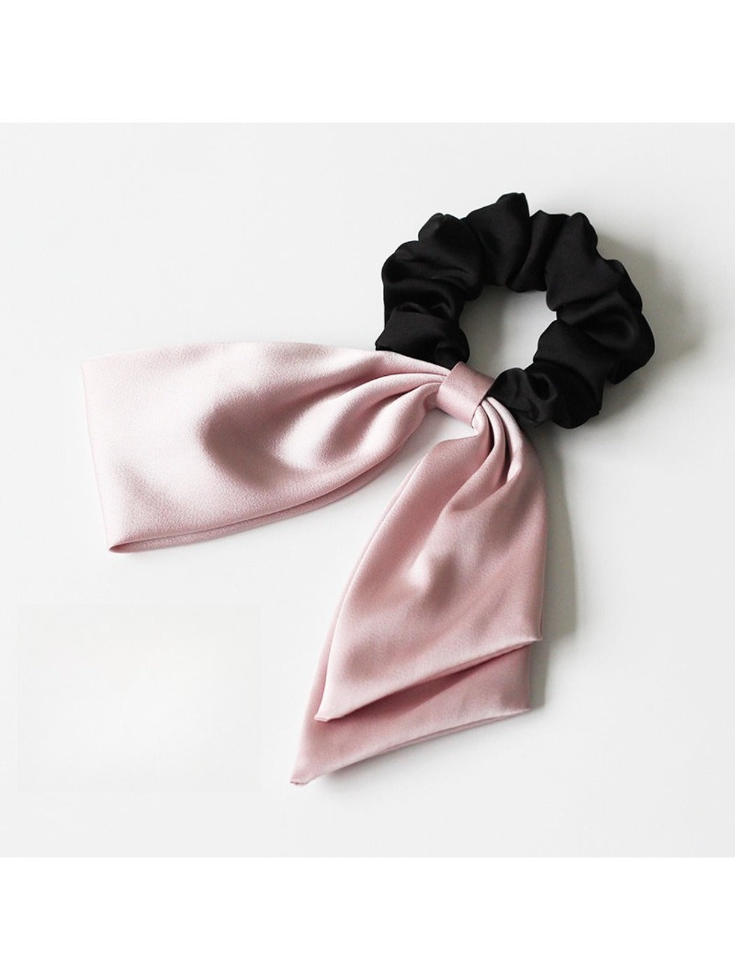 Model wearing satin bow hair tie with casual outfit and natural makeup