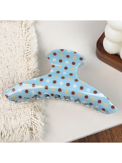 Blue polka dot hair claw clip open to show inner teeth