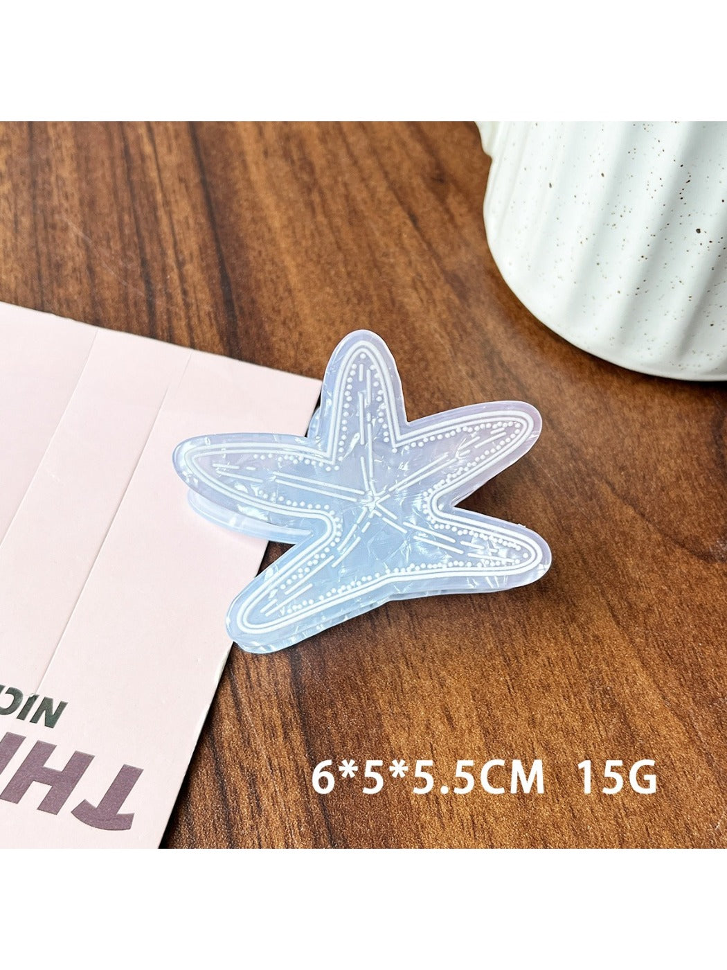Beau blue ocean style claw clip held in hand demonstrating size and grip