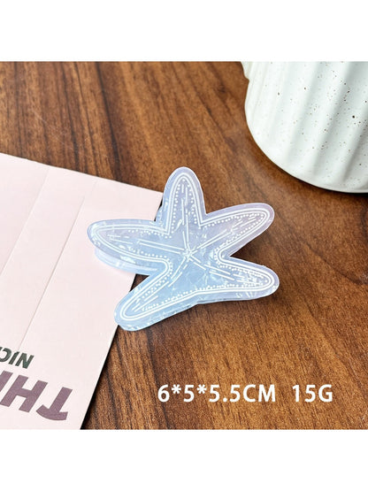 Beau blue ocean style claw clip held in hand demonstrating size and grip