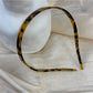 Top view of vintage leopard print hairband highlighting knot design