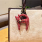 Keypus cartoon cat charm keychain photographed with soft lighting emphasizing its glossy finish