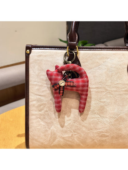 Keypus cartoon cat charm keychain photographed with soft lighting emphasizing its glossy finish