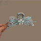 Beau Dreamy Floral Bow Hair Clip with pastel pink and white flowers on a soft fabric bow