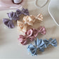Close-up of Beau satin bow banana clip showing smooth fabric texture
