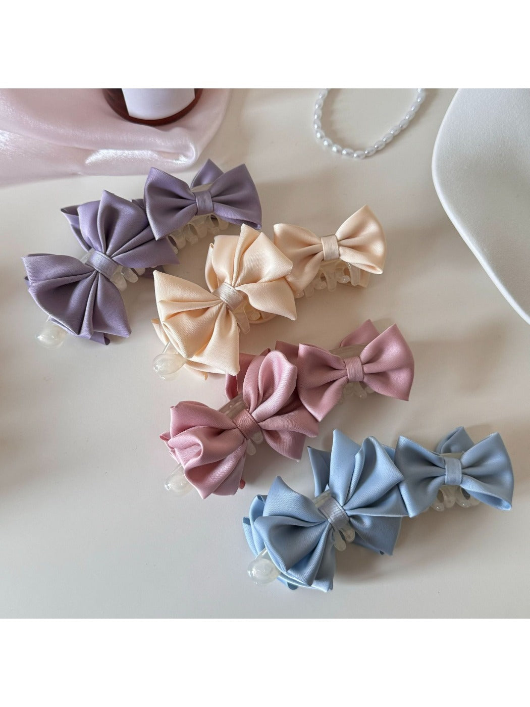 Close-up of Beau satin bow banana clip showing smooth fabric texture
