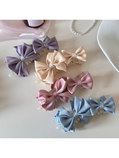 Close-up of Beau satin bow banana clip showing smooth fabric texture