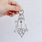 Close-up of heart shaped charm keychain showing detailed texture and shine