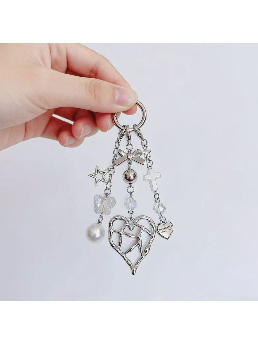 Close-up of heart shaped charm keychain showing detailed texture and shine