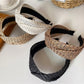 Bohemian wide crisscross headband in earthy tones displayed on a white background