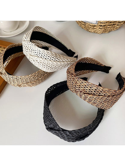 Bohemian wide crisscross headband in earthy tones displayed on a white background