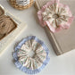 Gifty scrunchie displayed on a white background with visible floral design