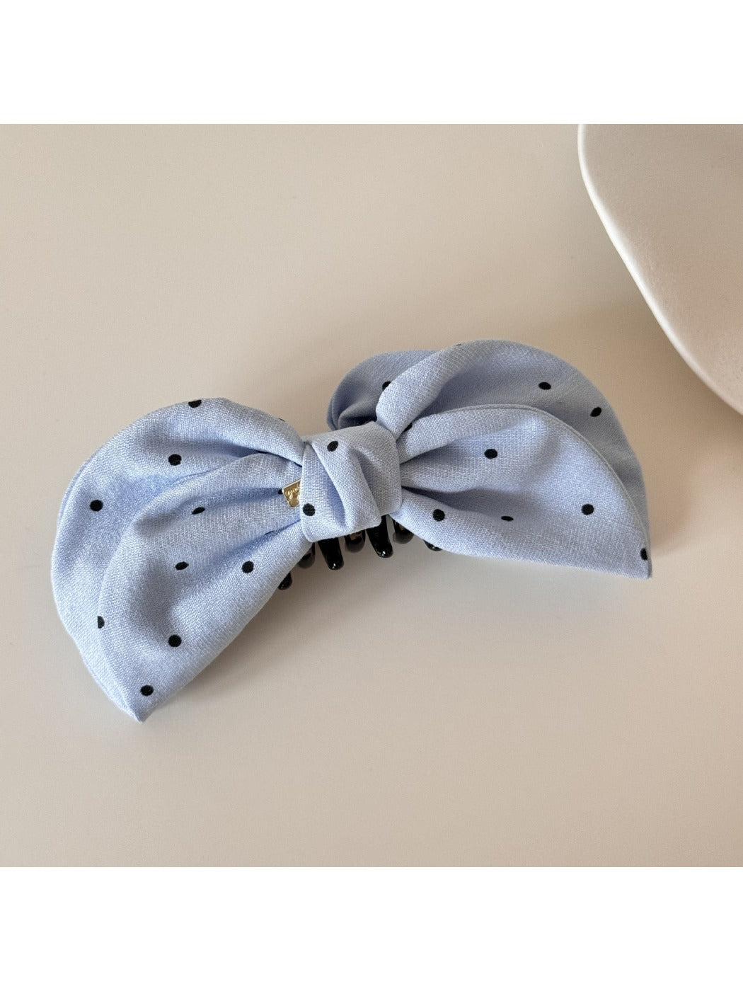 Beau elegant bow banana clip in black, angled view showing glossy finish